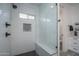Modern shower featuring white subway tile, a rainfall shower head, and black hexagonal floor tiles at 2345 N 28Th Pl, Phoenix, AZ 85008