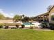 A spacious backyard features a lawn, landscaping, and a pool with waterfall features at 26409 N 49Th Ln, Phoenix, AZ 85083