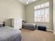 Cozy bedroom with twin beds, a white dresser, plush carpet, and a bright window with shutters at 26409 N 49Th Ln, Phoenix, AZ 85083