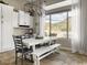 Open dining area with large window and backyard view with white furniture at 26409 N 49Th Ln, Phoenix, AZ 85083
