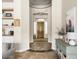 Elegant foyer showcasing tile floors, decorative columns, and a view of the front door at 26409 N 49Th Ln, Phoenix, AZ 85083