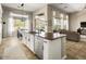 Open kitchen featuring a center island with seating, modern appliances, and views of the backyard at 26409 N 49Th Ln, Phoenix, AZ 85083