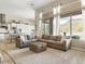 Open concept living room featuring a view to backyard, pool, and kitchen at 26409 N 49Th Ln, Phoenix, AZ 85083