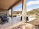 Spacious covered patio with mountain views, an outdoor seating area, and pool access for entertaining at 26409 N 49Th Ln, Phoenix, AZ 85083