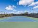 A pristine blue and green tennis court awaits players on a clear day in this active community at 26409 N 49Th Ln, Phoenix, AZ 85083