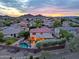 Sunset aerial view of a home featuring a private pool, covered patio, and mountain views at 27803 N 59Th Dr, Phoenix, AZ 85083