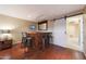 Basement bar area featuring wood floors, a barn door, and bar seating at 27803 N 59Th Dr, Phoenix, AZ 85083