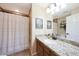 Well-lit bathroom features tile floors, granite countertops, and a shower with a curtain at 27803 N 59Th Dr, Phoenix, AZ 85083