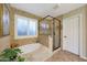 Well-lit bathroom featuring a glass shower, soaking tub, and tiled accents at 27803 N 59Th Dr, Phoenix, AZ 85083