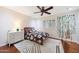 This bedroom features neutral walls, wood floors, and a ceiling fan at 27803 N 59Th Dr, Phoenix, AZ 85083