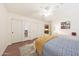 This bedroom offers neutral walls, wood floors, and a ceiling fan at 27803 N 59Th Dr, Phoenix, AZ 85083