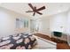 Bright bedroom showcasing hardwood floors, natural light, and a ceiling fan at 27803 N 59Th Dr, Phoenix, AZ 85083