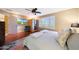 Comfortable bedroom featuring wood floors, window with shutters, sauna, and a TV at 27803 N 59Th Dr, Phoenix, AZ 85083