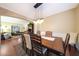 Elegant dining room with a large wooden table, seating for eight, and seamless access to the living area at 27803 N 59Th Dr, Phoenix, AZ 85083