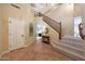 Inviting foyer with tile flooring, a staircase, and a view into the living area, creating a warm and open feel at 27803 N 59Th Dr, Phoenix, AZ 85083