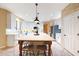 Bright kitchen features white cabinets, stainless appliances, large island with seating, and modern pendant lighting at 27803 N 59Th Dr, Phoenix, AZ 85083