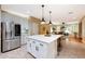 Beautiful kitchen featuring a large island with seating, stainless steel appliances, and open layout at 27803 N 59Th Dr, Phoenix, AZ 85083