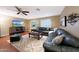 Spacious living room with hardwood floors, ceiling fan, and a large leather sectional at 27803 N 59Th Dr, Phoenix, AZ 85083