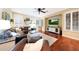 Comfortable living room features large sectional couch, tv, shutters and attractive decor at 27803 N 59Th Dr, Phoenix, AZ 85083