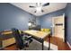 Office with neutral walls, wood floors, a desk and a view into another room at 27803 N 59Th Dr, Phoenix, AZ 85083