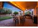 Outdoor patio area with string lights, a ceiling fan, outdoor kitchen, and dining space at 27803 N 59Th Dr, Phoenix, AZ 85083