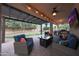 Covered patio featuring cozy seating, a fire table, and a view of the landscaped backyard at 27803 N 59Th Dr, Phoenix, AZ 85083