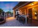 Covered patio featuring an outdoor dining area and a built-in grill, ideal for entertaining at 27803 N 59Th Dr, Phoenix, AZ 85083
