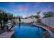 Inviting backyard pool area with rock features, lush landscaping, and comfortable seating at 27803 N 59Th Dr, Phoenix, AZ 85083