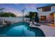 Beautiful pool featuring a rock waterfall, basketball hoop, and landscaped surroundings at 27803 N 59Th Dr, Phoenix, AZ 85083