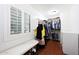 Bright walk-in closet with hardwood floors, custom shelves, and a window seat at 27803 N 59Th Dr, Phoenix, AZ 85083