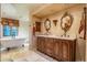 Elegant bathroom featuring a clawfoot tub, custom vanity, and decorative mirrors at 29 E Oakwood Hills Dr, Chandler, AZ 85248