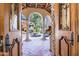 Mediterranean-style courtyard with a stone fountain, arched walkways, and lush landscaping at 29 E Oakwood Hills Dr, Chandler, AZ 85248