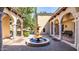 Tranquil courtyard features an ornate stone fountain and arched walkways with elegant columns at 29 E Oakwood Hills Dr, Chandler, AZ 85248