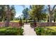 Picturesque gated garden with a stone fountain, leading to open green spaces at 29 E Oakwood Hills Dr, Chandler, AZ 85248