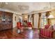 Elegant living room with hardwood floors, ornate ceiling details, and custom drapery at 29 E Oakwood Hills Dr, Chandler, AZ 85248
