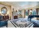 Elegant living room boasting a stone fireplace, piano and decorative mirror at 29 E Oakwood Hills Dr, Chandler, AZ 85248