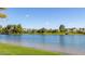 Scenic view of a tranquil pond surrounded by lush trees and green grass on a clear day at 29 E Oakwood Hills Dr, Chandler, AZ 85248