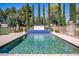 Beautiful pool with a brick surround, water feature, and fence in a landscaped backyard at 29 E Oakwood Hills Dr, Chandler, AZ 85248