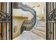 Gorgeous winding staircase with decorative iron railing and travertine steps at 29 E Oakwood Hills Dr, Chandler, AZ 85248