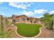 Landscaped backyard featuring an artificial putting green, pool, and built-in grill at 2959 W Eastman Dr, Anthem, AZ 85086