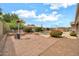 Landscaped backyard featuring a paver patio, mature trees, vibrant plants, and outdoor seating, perfect for relaxation at 2959 W Eastman Dr, Anthem, AZ 85086