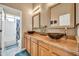 A bright bathroom with double vessel sinks, granite counters, and a bathtub/shower combo at 2959 W Eastman Dr, Anthem, AZ 85086