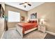 A cozy bedroom with a ceiling fan, soft carpet, and a bright window at 2959 W Eastman Dr, Anthem, AZ 85086
