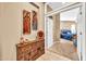 Foyer with artwork that leads to a bedroom with a luxurious blue bed at 2959 W Eastman Dr, Anthem, AZ 85086