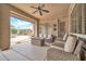 Relaxing covered patio with comfortable seating, ceiling fan, and a view of the backyard and pool area at 2959 W Eastman Dr, Anthem, AZ 85086