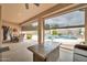 Inviting covered patio with outdoor dining, a cozy seating area, and views of the lush backyard and pool at 2959 W Eastman Dr, Anthem, AZ 85086