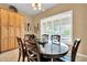 Inviting dining room with dark wood table, modern lighting, and shuttered windows at 2959 W Eastman Dr, Anthem, AZ 85086
