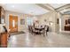 Spacious dining room with a chandelier, tile flooring, and a wooden front door at 2959 W Eastman Dr, Anthem, AZ 85086