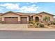 Inviting single-story home with a three-car garage and a well-maintained desert-style front yard at 2959 W Eastman Dr, Anthem, AZ 85086