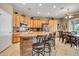 Bright kitchen with granite island, wooden cabinetry, stainless appliances and a breakfast nook at 2959 W Eastman Dr, Anthem, AZ 85086